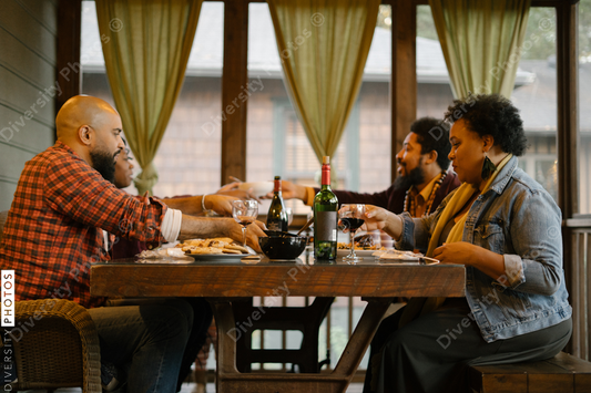 Black friends eating dinner together for date night get together