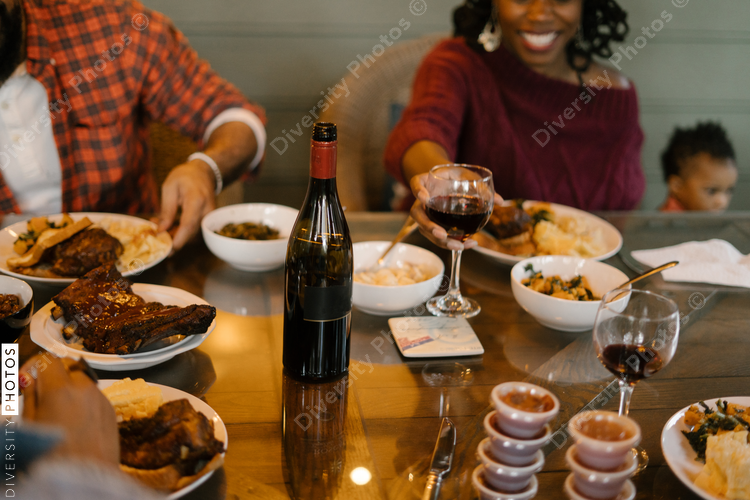 Friends eating BBQ together safely in vacation pod during pandemic