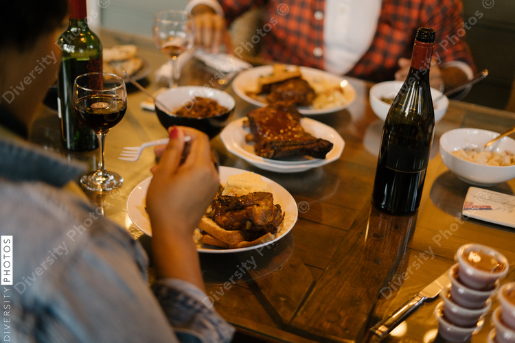 Friends eating BBQ together safely in vacation pod during pandemic