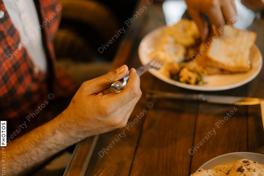 Black friends eating and talking over meal together