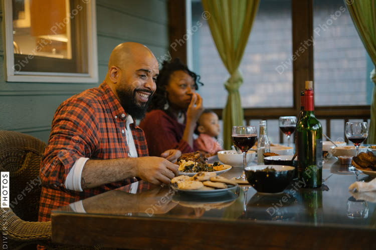Friends eating BBQ together safely in vacation pod