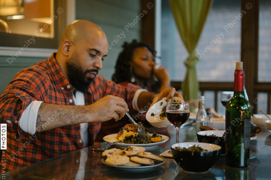 Black friends enjoying dinner and wine together while on vacation