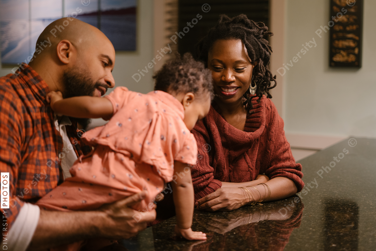 African American mom and dad spending quality time with daughter at home
