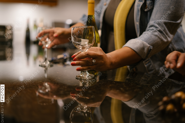 Friends having a drink together at house party gathering