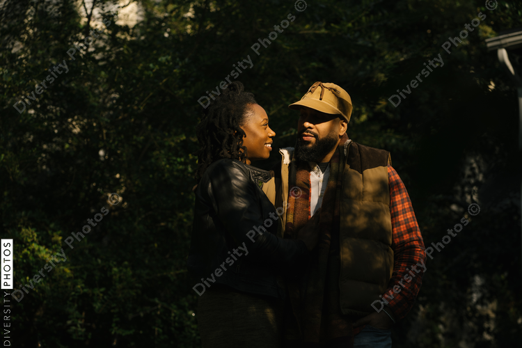 Portrait of black husband and wife couple outdoors in fall and in love