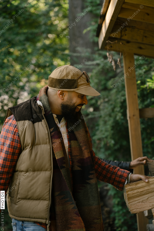 Black man getting firewood for fire-pit