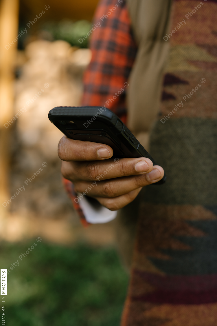 Man with smartphone in backyard enjoying technology