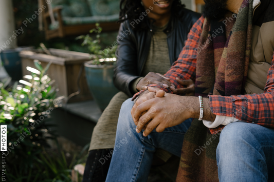 Beautiful black couple talking on front porch at home
