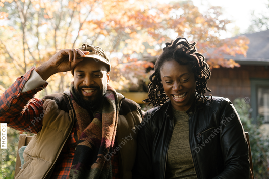 Black couple spending quality time together on front porch swing at home