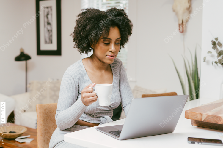 Woman working from home, drinks morning coffee