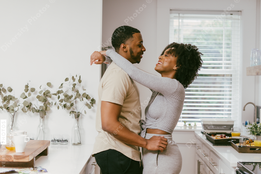 Black couple dancing in kitchen at home, intimate moment