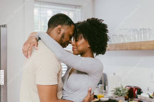 Black couple dancing in kitchen at home, intimate moment