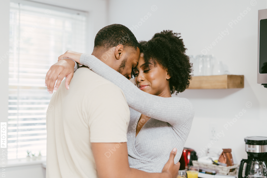 Black couple dancing in kitchen at home, intimate moment