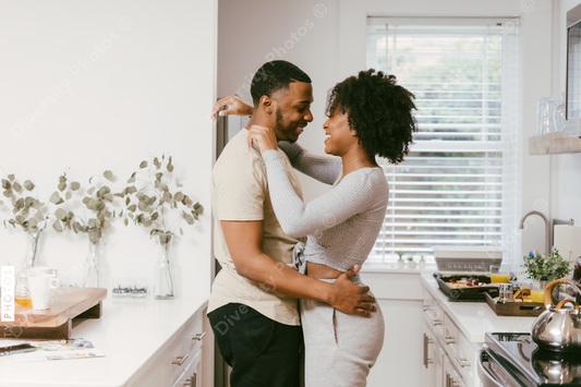 Black couple dancing in kitchen at home, intimate moment