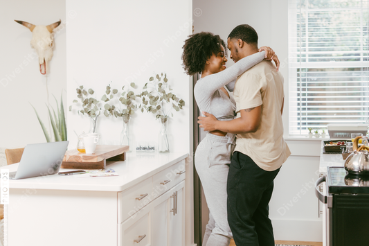 Black couple dancing in kitchen at home, intimate moment