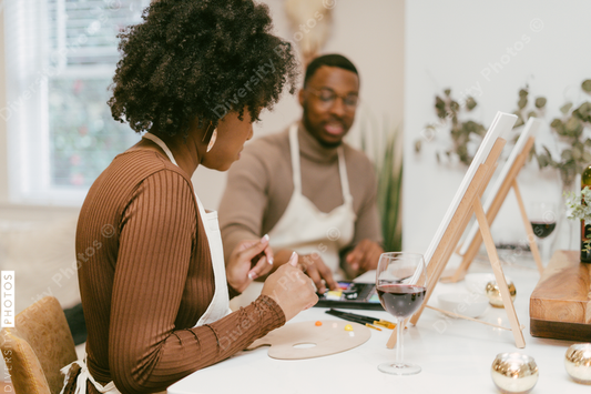 Black couple having at home date night, painting romantic DIY