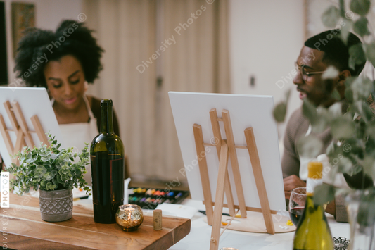 Black couple having at home date night, painting romantic DIY
