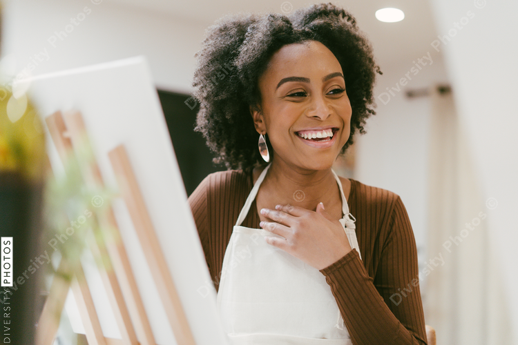 Black Woman laughing and enjoying painting date night, DIY
