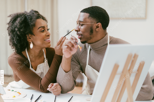 Black couple has fun painting and laughing during date night, paint and craft DIY