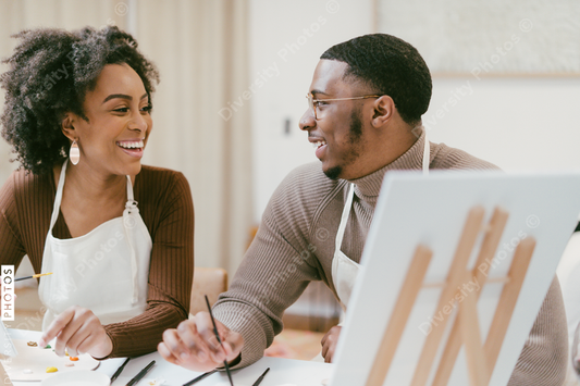Black couple has fun painting and laughing during date night, paint and craft DIY