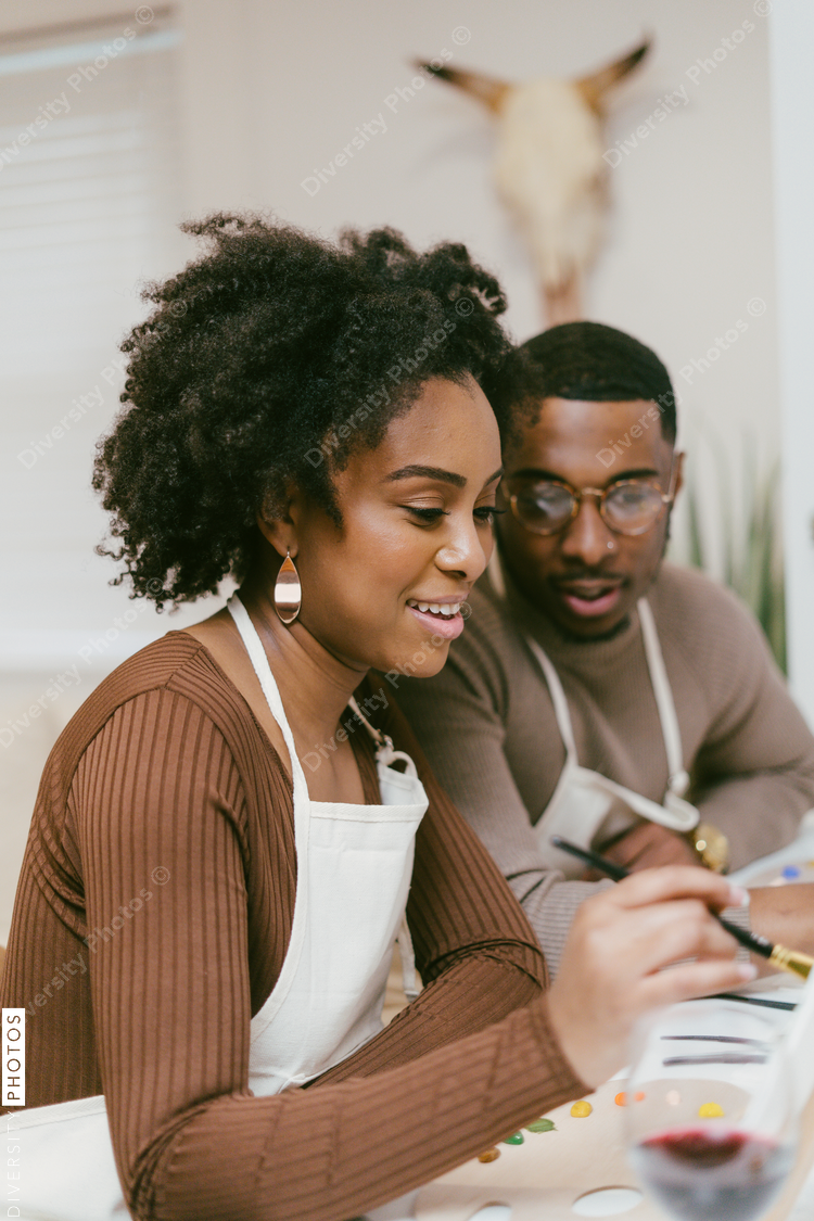 Man watches girlfriend finish painting, date night