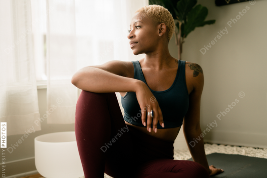 Young woman practices yoga at home