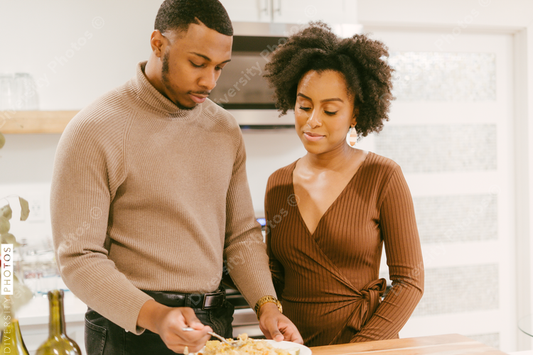 Black man feeds girlfriend dinner, intimate moment