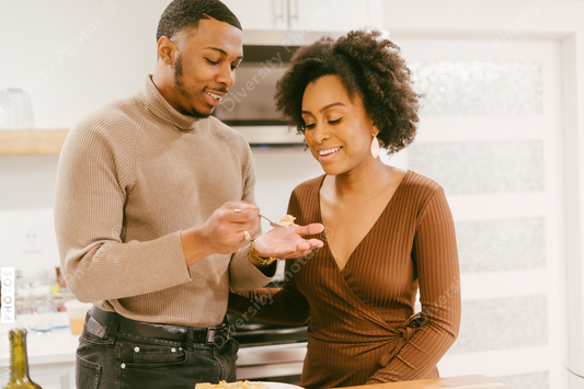 Black man feeds girlfriend dinner, intimate moment