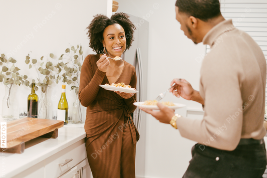 Young couple eats takeout at home in kitchen, date night at home