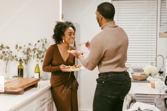 Young couple eats takeout at home in kitchen, date night at home