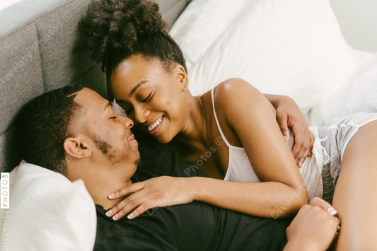 Young couple relaxing on bed at home, African American boyfriend and girlfriend love connection