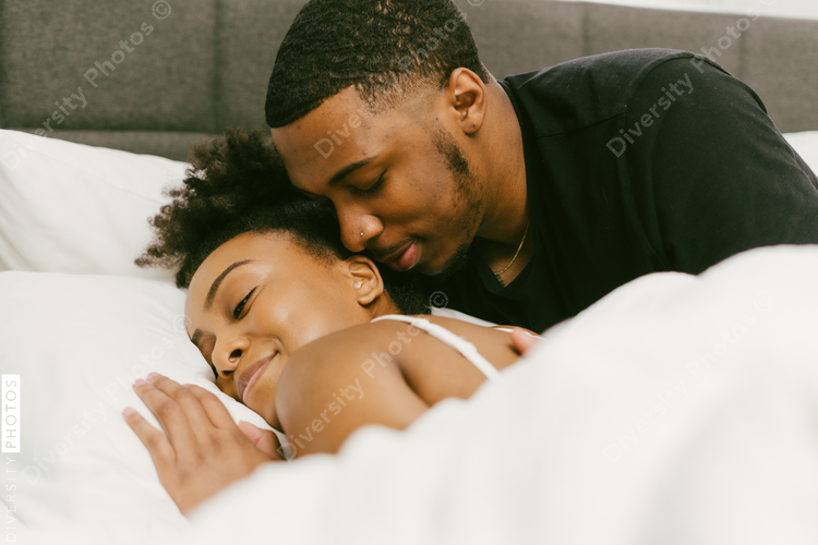 Boyfriend waking up girlfriend from sleep, weekend morning