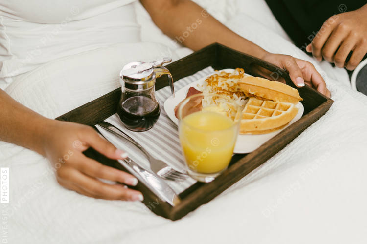 Couple enjoys breakfast in bed at home