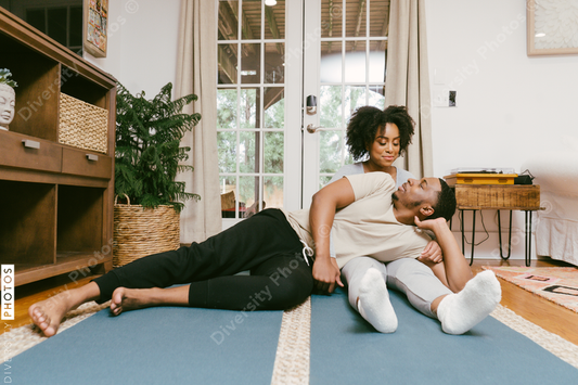 Black couple stretches and workout at home together