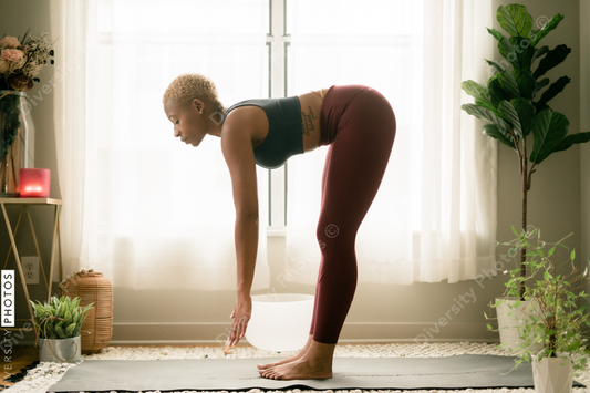 Young woman practices yoga at home