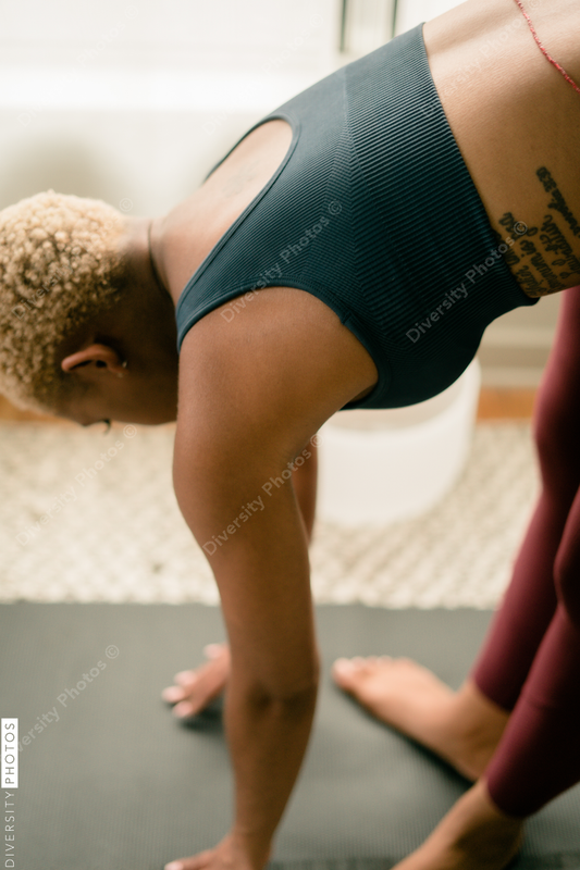 Young woman practices yoga at home