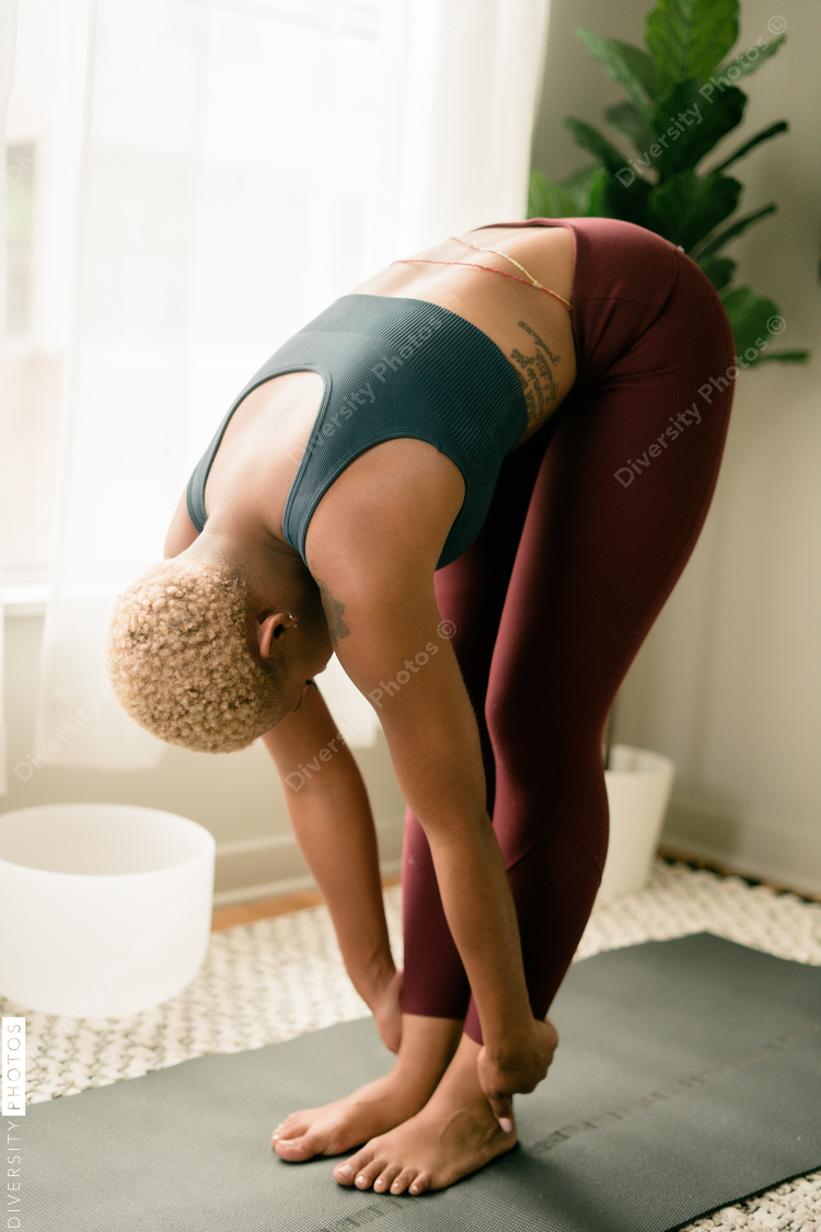 Young woman practices yoga at home
