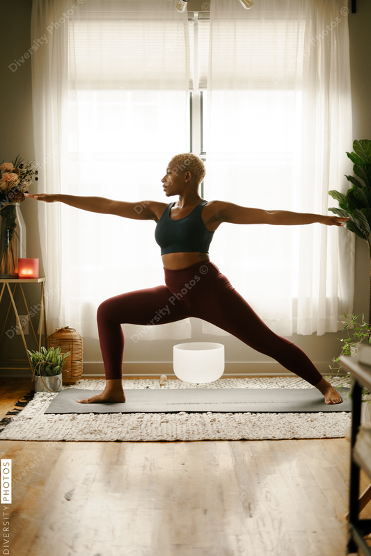 Young woman practices yoga at home