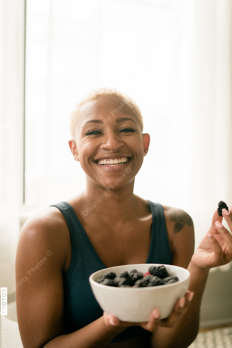 Black woman eating healthy fruit and berries