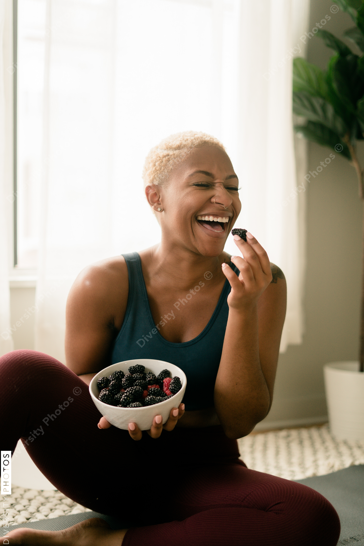 Black woman eating healthy fruit and berries