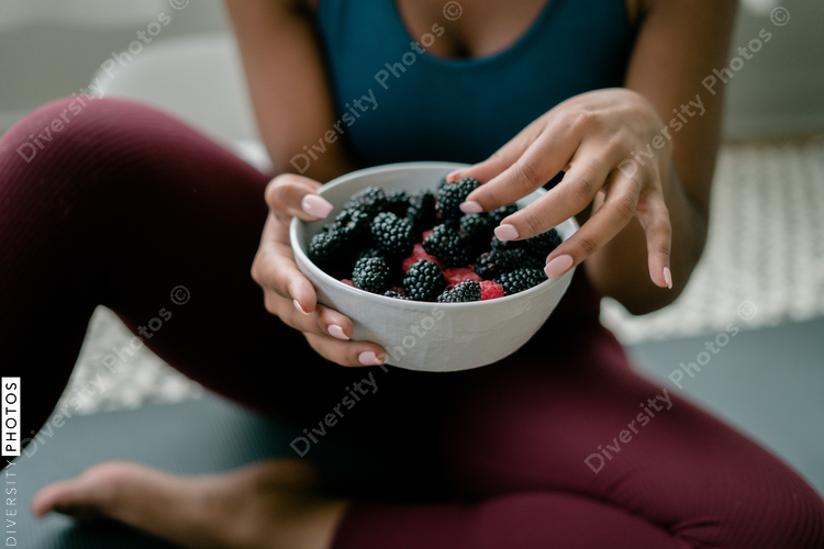 Black woman eating healthy fruit and berries
