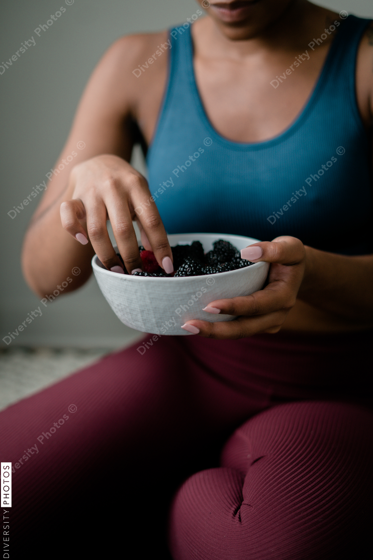 Black woman eating healthy fruit and berries