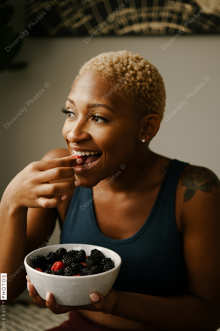 Black woman eating healthy fruit and berries