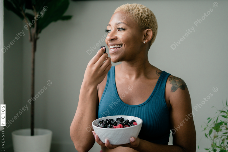 Black woman eating healthy fruit and berries