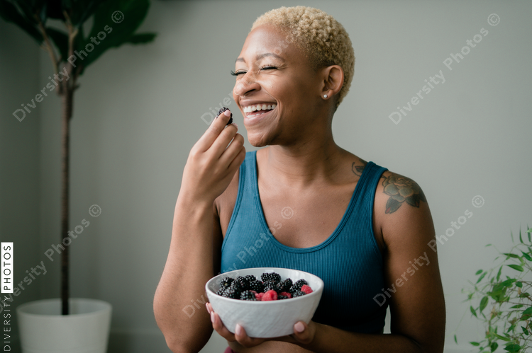 Black woman eating healthy fruit and berries