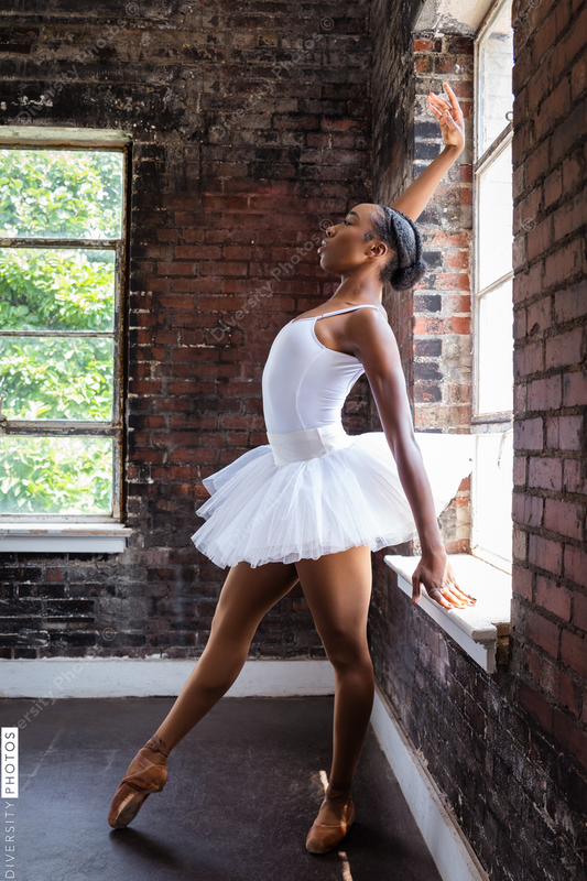 Black ballerina doing powerful ballet dance pose
