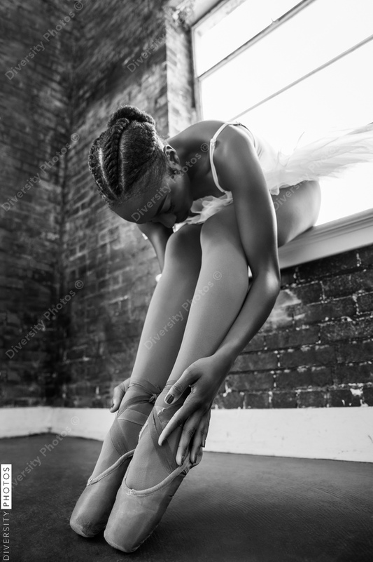 Black ballerina doing powerful ballet dance pose