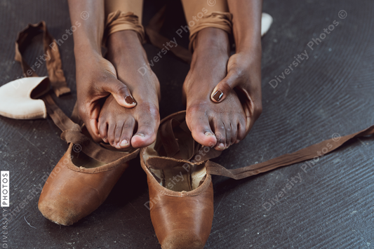 Black ballerina dancer takes off pointe shoes, pushing through pain, perseverance 