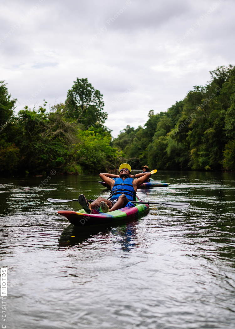 Relaxed man kayaking on calm river