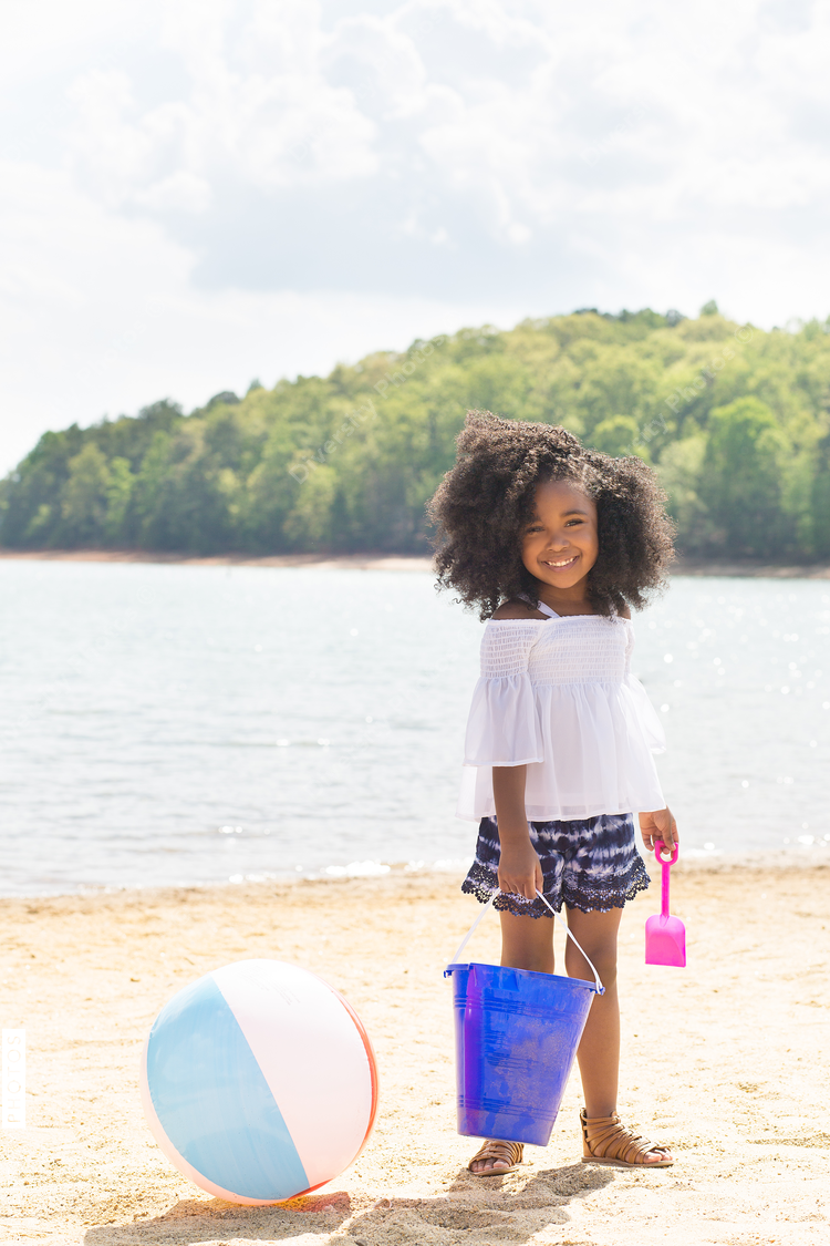 Portrait of smiling girl standing on the beach